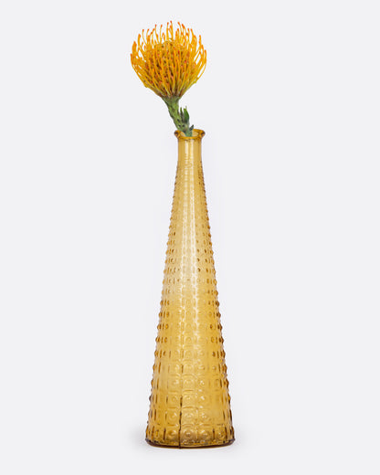 Vintage tall tapered amber glass vase from Italy, with a hobnail texture, holding an orange flower