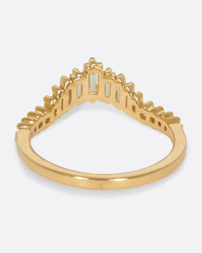 A curved crown ring lined with baguette diamonds. Shown from the back.