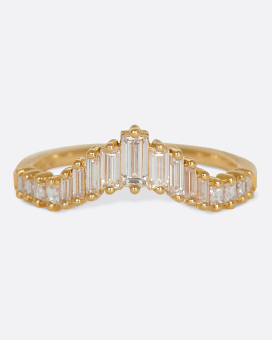 A curved crown ring lined with baguette diamonds.