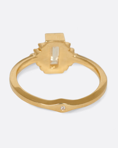A large diamond baguette sits at the center of this ring, flanked by five additional baguettes on either side. Shown from the back.