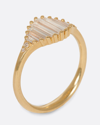 A signet ring with a face made entirely of baguette diamonds. Shown from the side standing up.