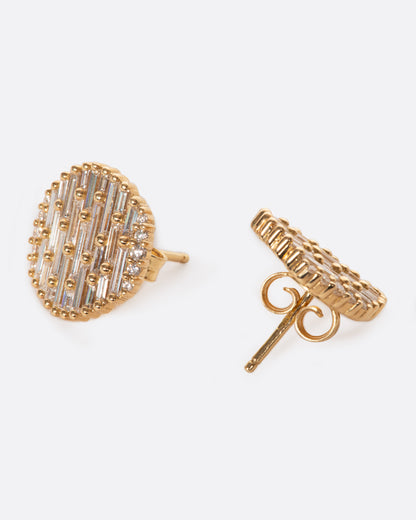 A pair of round yellow gold, slightly concave stud earrings covered in baguette diamonds.One earring is shown from the front, the other is shown from the back.