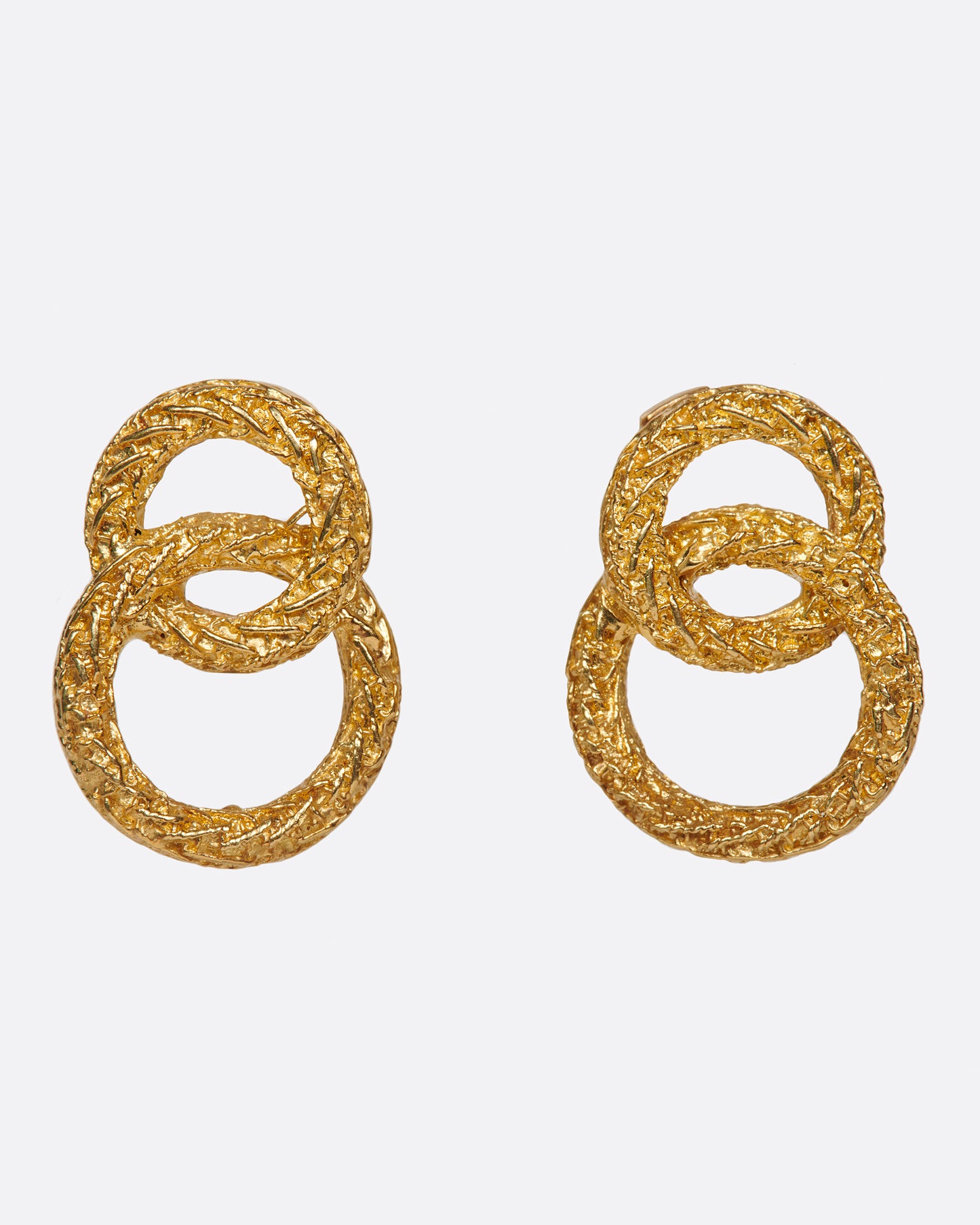 A pair of textured double-circle stud earrings. Shown from the front.