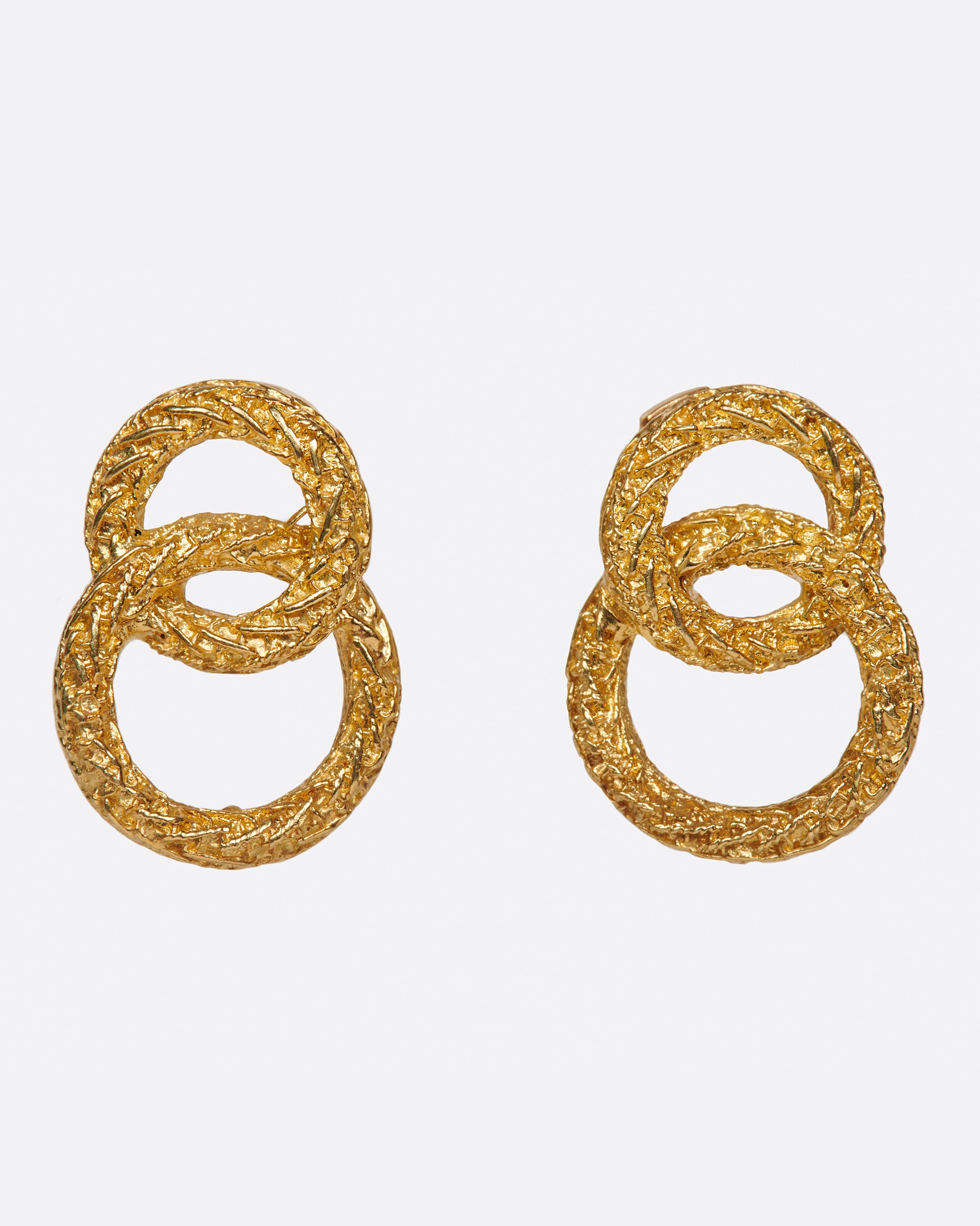 A pair of textured double-circle stud earrings. Shown from the front.
