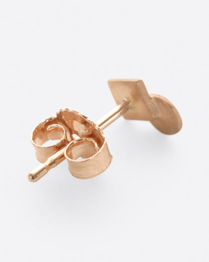 A rose gold square stud earring with overlapping circle and matte finish. Shown diagonally from the back.