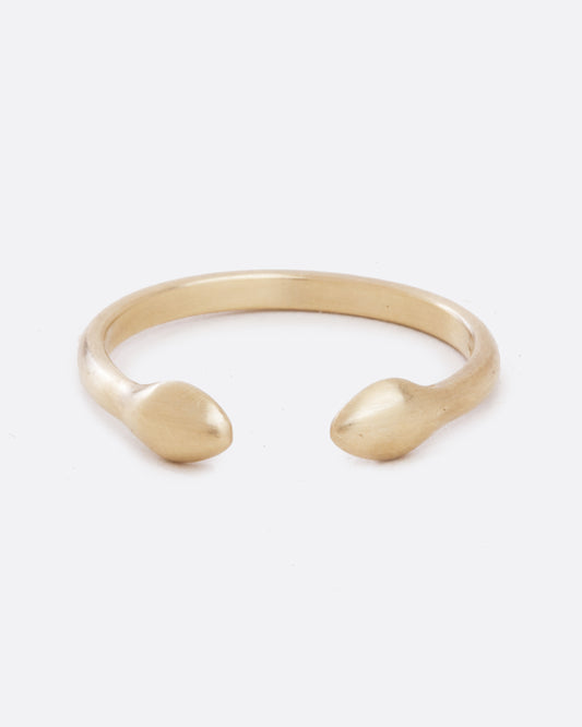 A yellow gold ring with an open front. The front pieces are more bulbous than the band. Shown from the front.