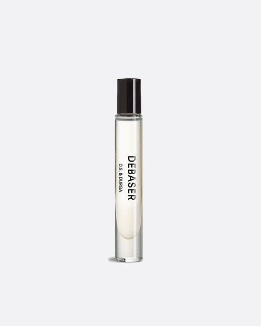 A glass roll on perfume bottle with a shiny black top and writing on its side that reads: Debaser D.S. & Durga. Shown standing up from the front.