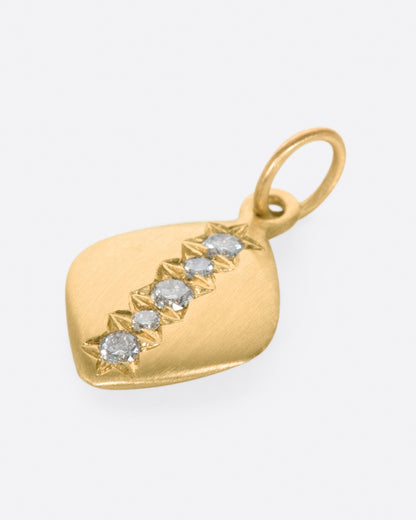 A rounded square tag with a line of gray diamonds down the center. Shown lying flat.