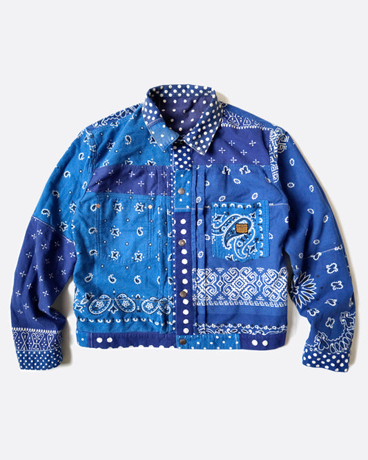 A blue flannel jacket in a patchwork bandana pattern, shown lying flat from the front.