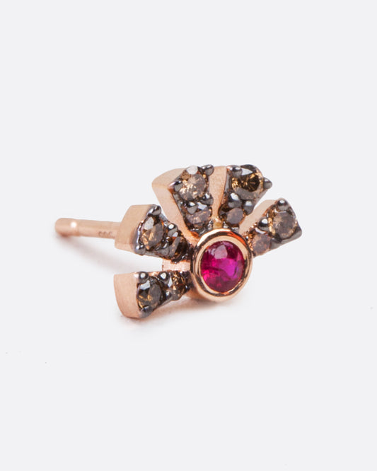A single rose gold earring with a ruby in the middle and five black diamond pave bars extending from the ruby. Shown diagonally from the front.
