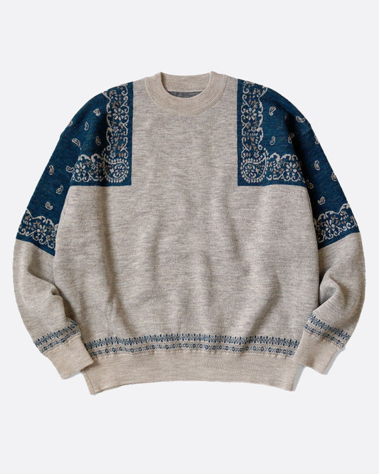 A gray crew neck sweater with navy bandana print on the shoulders. Shown from the front. 
