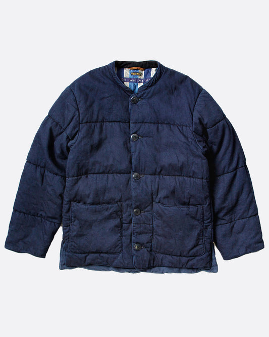 A navy quilted denim jacket with button closure and two front pockets, shown from the front.