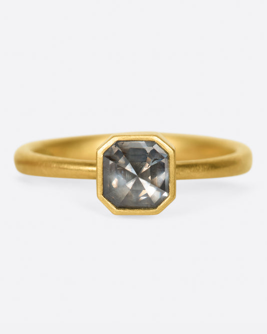 A yellow gold ring with a smokey octagonal diamond. Shown from the front.
