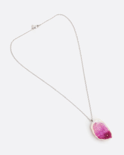 A large freshwater souffle pearl carved out and lined with ombre pink sapphires and seed pearls. It has a pave diamond lined bail and white gold cable chain. Shown from the front lying flat with the clasp closed.