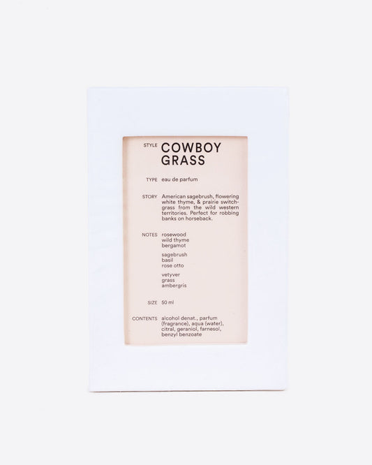 A white box with a cutout window showing product information of D.S. & Durga Eau De Parfum: Cowboy Grass. Shown from the front.