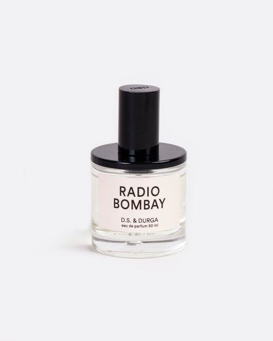 A glass bottle with a label that reads: Radio Bombay D.S. & Durga eau de parfum 50 ml with black shiny spritzer top. Shown from the front.