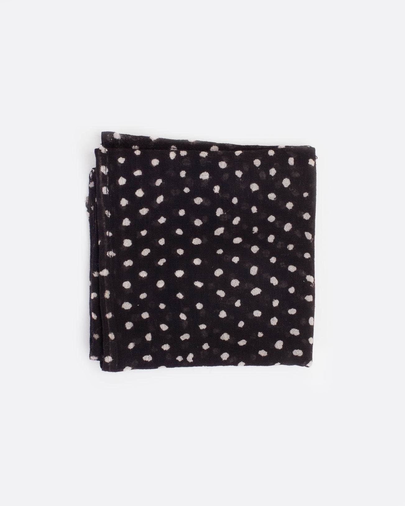 Black bandana with white polka dots, shown folded.