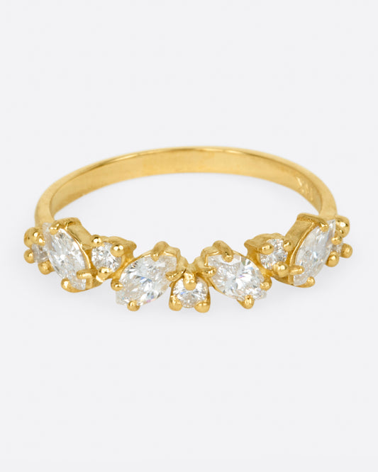A yellow gold ring with round and marquise diamonds. Shown from the front.