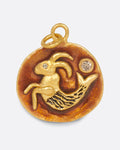 A yellow gold round pendant featuring a hand-sculpted Capricorn symbol with diamond accents. Shown from the front.