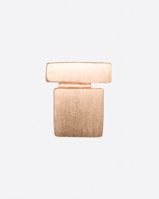 A matte rose gold stud earring with a bar stacked on a square. Shown from the front.