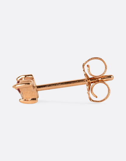 A yellow gold stud earring with a princess cut diamond at the center and two round pink sapphires on either side. View from the side.