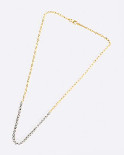 A yellow gold, oval link chain necklace with four inches of contrasting white diamonds, shown from the front.