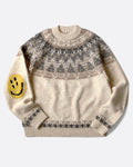 A crewneck pullover sweater with a Nordic pattern around the shoulders and smiley faces on the elbows, shown lying flat from the front.