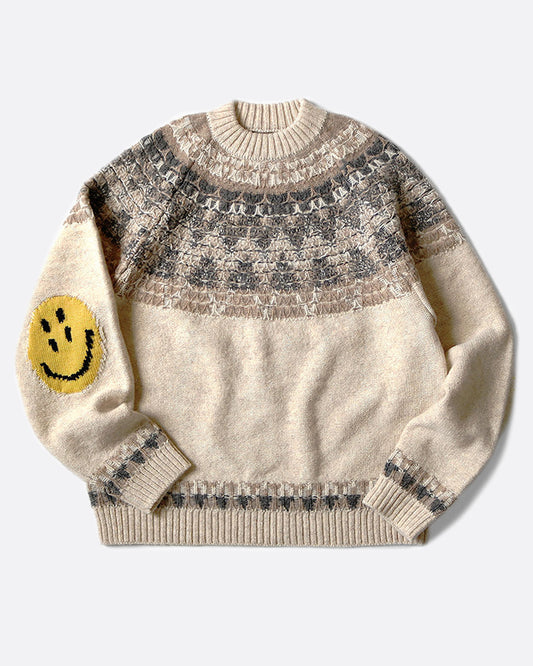 A crewneck pullover sweater with a Nordic pattern around the shoulders and smiley faces on the elbows, shown lying flat from the front.