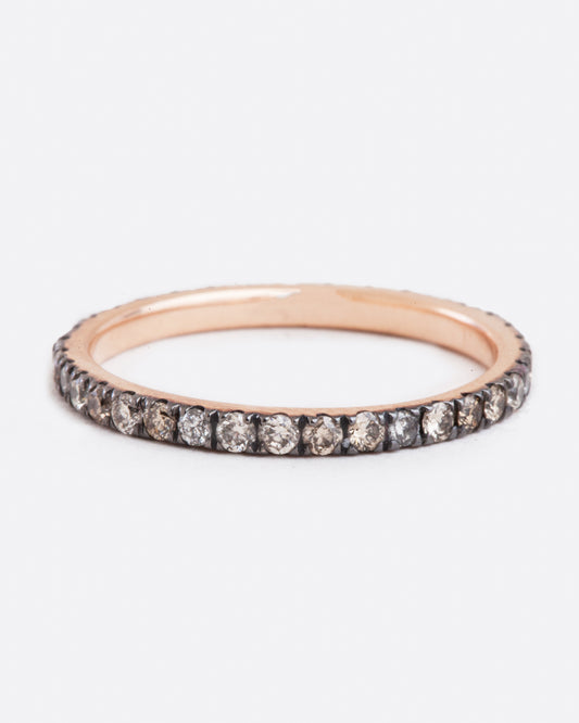 A rose gold ring with champagne and grey diamonds. Shown from the front.