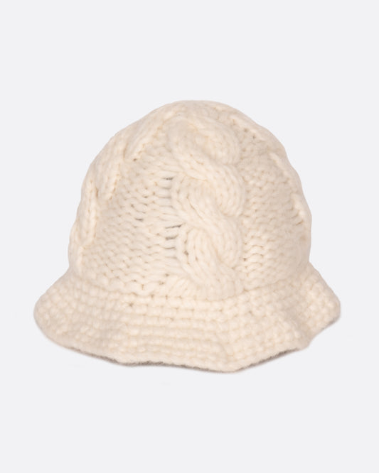 A chunky white cable knit bucket hat with a narrow brim. Shown from the front.