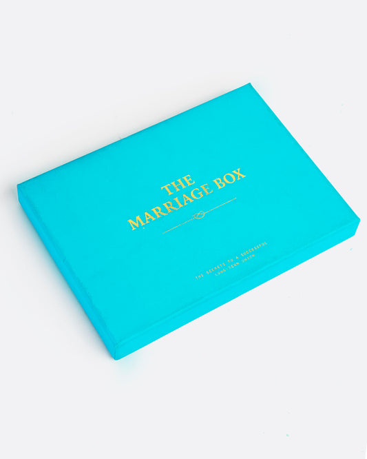 A turquoise box with THE MARRIAGE BOX in gold lettering on top. Shown at an angle from the top.