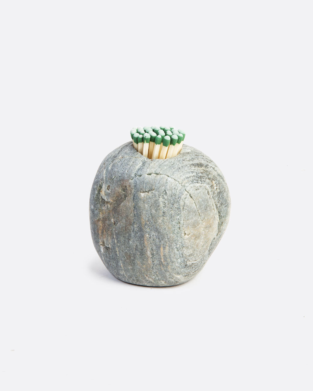 A stone match striker that is light grey with matches in a hole on the top. Shown from the front.