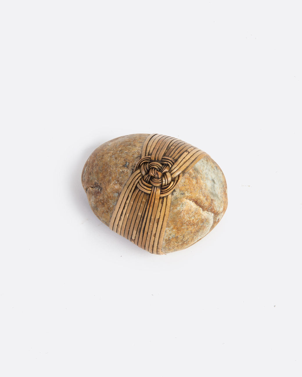 A blessing stone, wrapped in woven grass. Shown from the top.