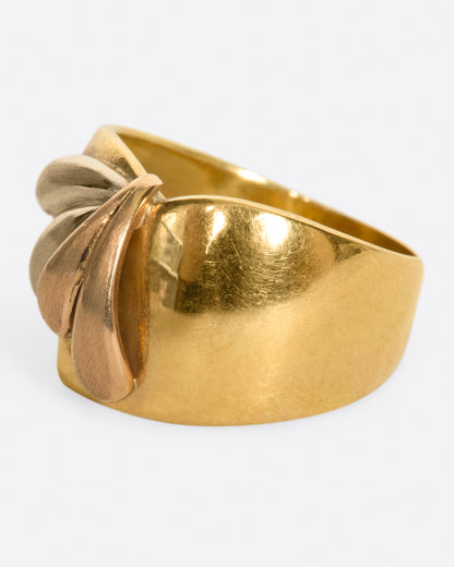A wide, dimpled yellow gold band with white and rose gold teardrop accents. Shown from the side.