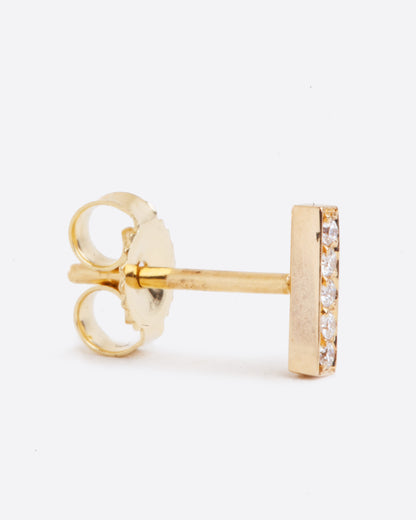 14k yellow gold bar stud earring with five white diamonds by Selin Kent, shown standing up from the side.