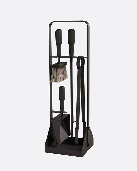 A black stand with four fireplace tools with black leather details on them. Shown from the front. 